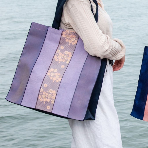 Lovely Purple and Lavender Striped Large Tote Bag with Purple and Pink Floral Designs on Center Stripe. Fabric Made in Japan| Boxy Bottom Tote Bag, Small Batch Production| Handbags Made in the USA| Durable, High Quality, Ultra Light Tote Bags| Made in the Finger Lakes, NY | Totes for  Women, Teachers, Moms| Best Totes for Work, Beach, Market, School, College|  Shop our Online Store ShimaShima Bags