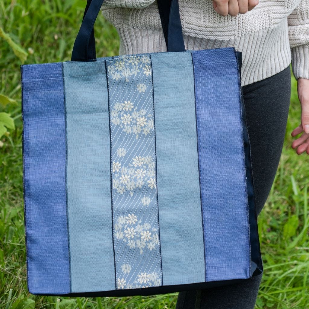 Close up image of woven fabric, Light Blue Shades, Floral Design, Japanese Vibe, Super Durable Fabric, Double Stitched Handles, Shoulder Straps, Heavy Duty Stitching on Corners and Seams. Long lasting Sustainable Tote Bags ShimaShima Bags